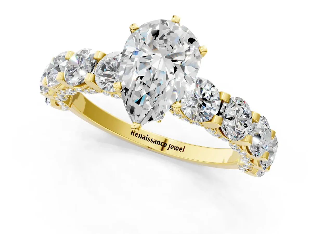Pear Cut Diamond Side Stone Engagement Ring with Four-Prong Setting Yellow gold