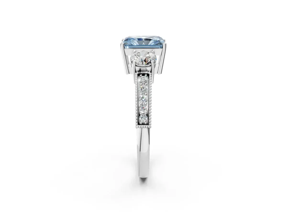Fancy Blue Radiant Cut Three-Stone Diamond Ring with Pavé Band and Four-Prong Setting Platinum