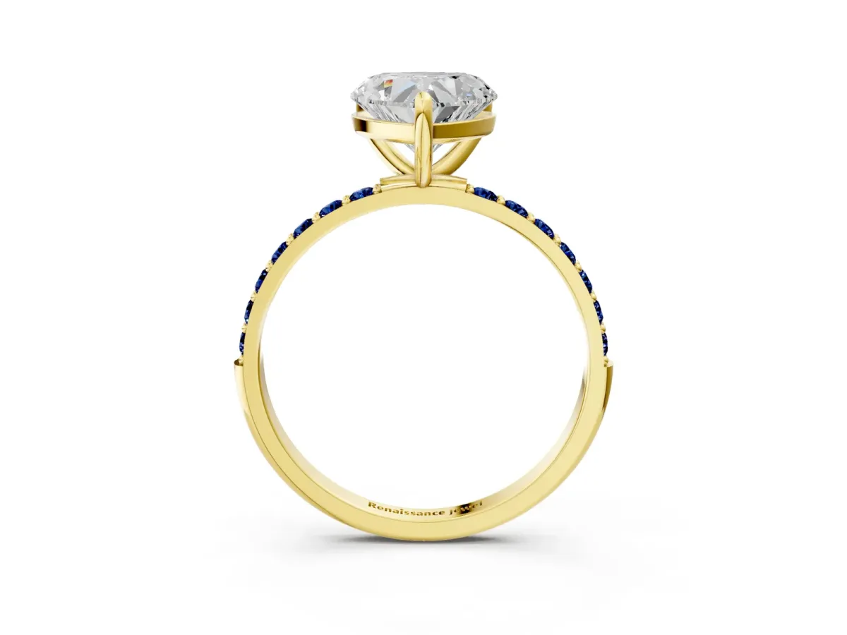 Heart Cut Diamond Solitaire Ring with Round Blue Sapphire Pavé Band and Prong Setting Yellow gold