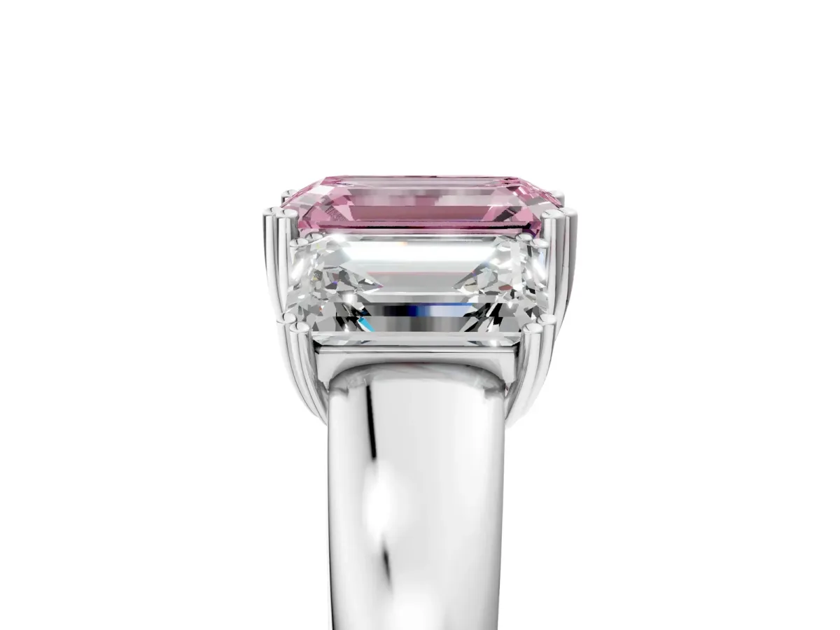 Fancy Pink Three-Stone Emerald Cut Cut Diamond Ring with Channel Set Band and Four-Prong Setting Platinum