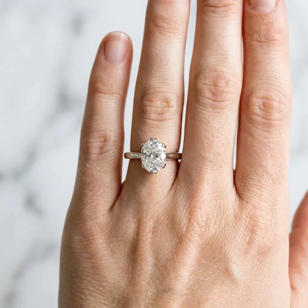 Oval Cut Diamond Solitaire Ring with Flower Prong Setting and Classic Band Silver