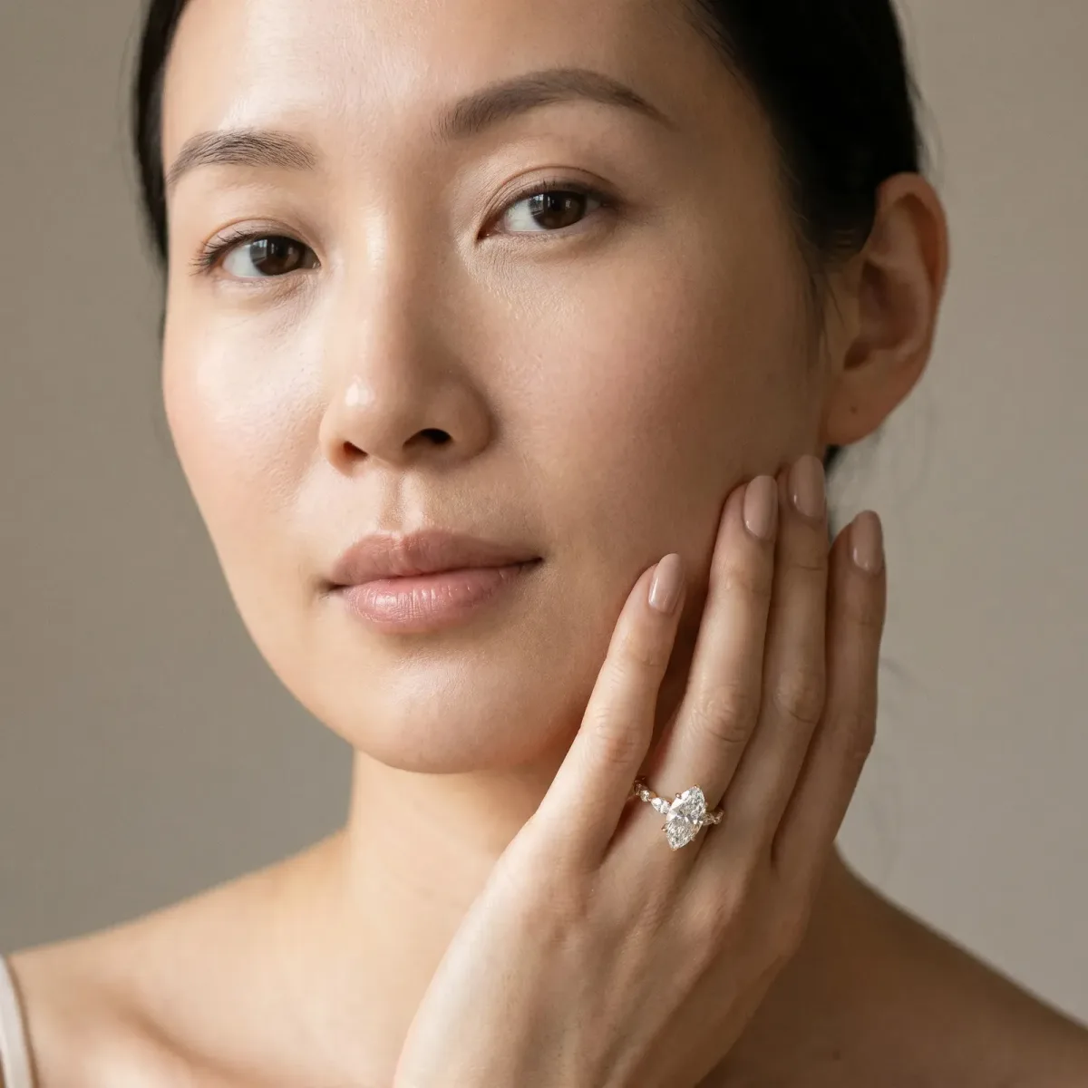 Marquise Cut Diamond Ring with Marquise and Round Side Stones and Four-Prong Setting Yellow gold