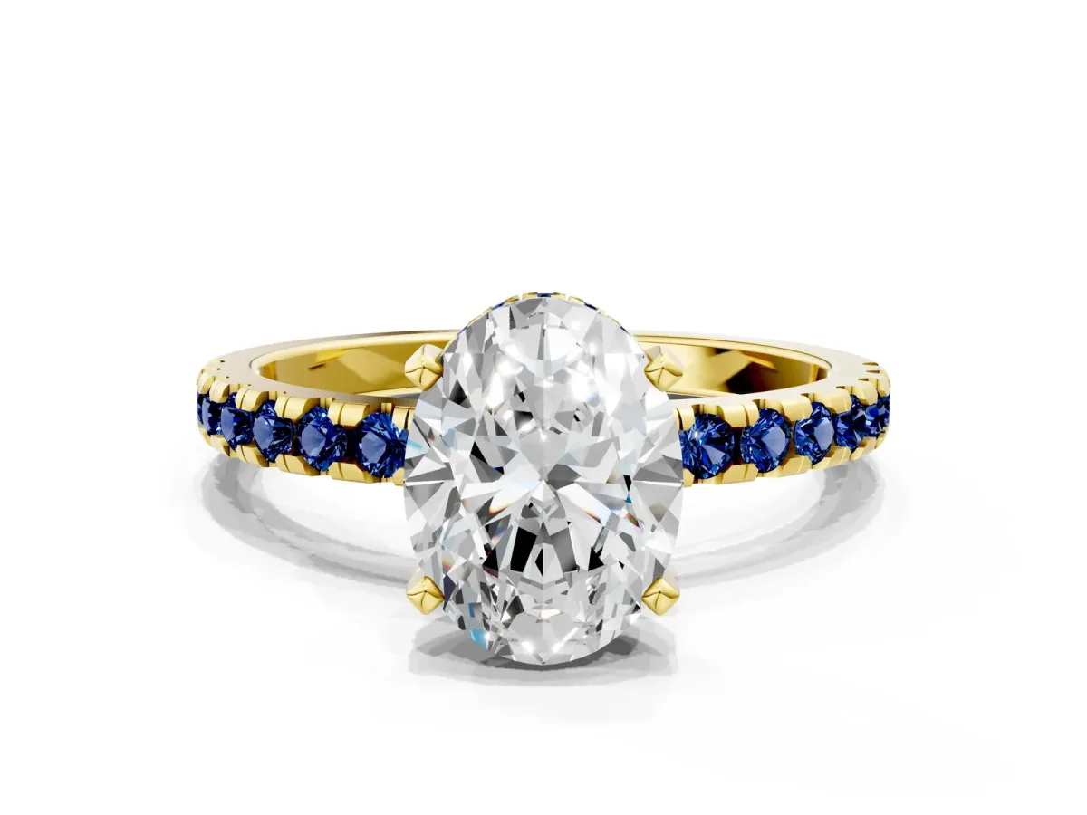 Oval Cut Diamond Solitaire Ring with Round Blue Sapphire Pavé Band and Four-Prong Setting Yellow gold