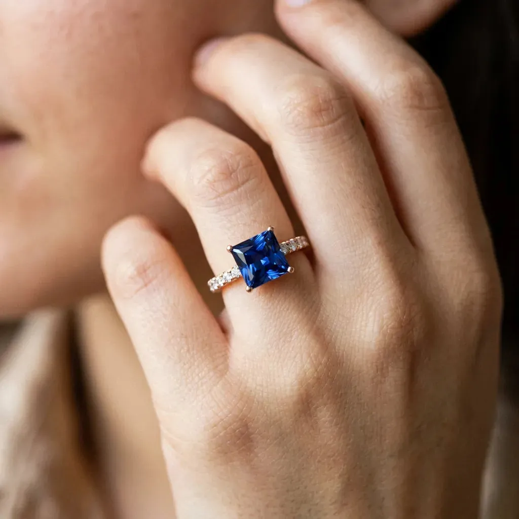 Princess Cut Blue Sapphire Solitaire Ring with Round Pavé Band and Four-Prong Setting Rose gold