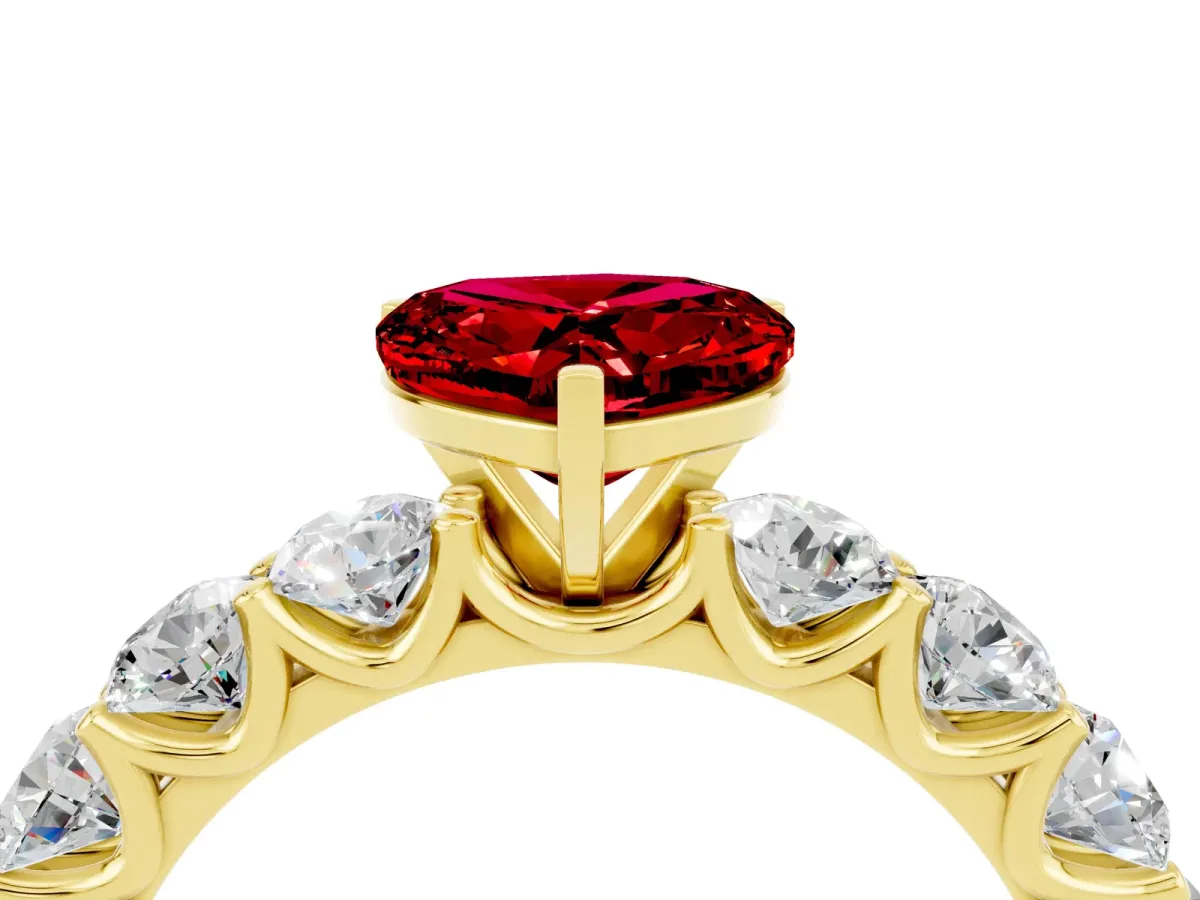 Heart Cut Ruby Prong Setting with Side Stones on a Pave Band Yellow gold