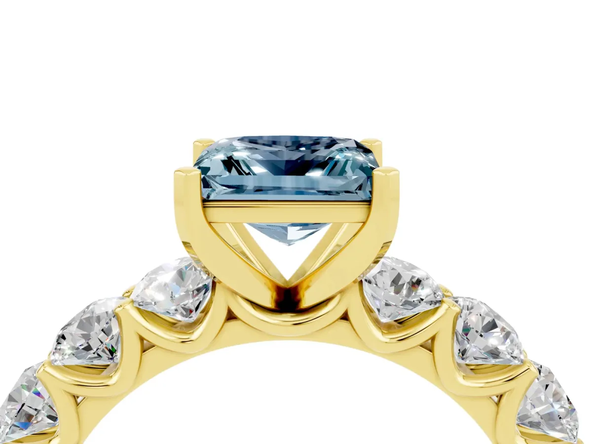 Princess Cut Aquamarine Prong Setting with Side Stones on a Pave Band Yellow gold