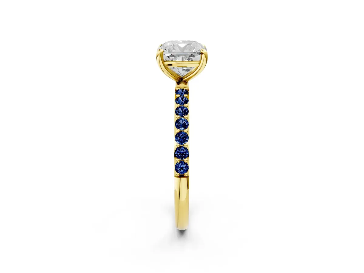 Cushion Cut Diamond Solitaire Ring with Round Blue Sapphire Pavé Band and Prong Setting Yellow gold