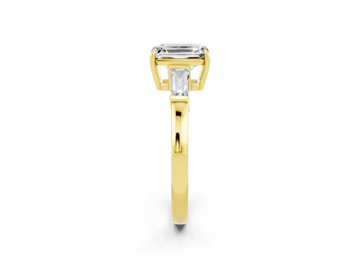 Emerald Cut Moissanite Three-Stone Ring with Tapered Baguette Side Stones and Prong Setting Yellow gold