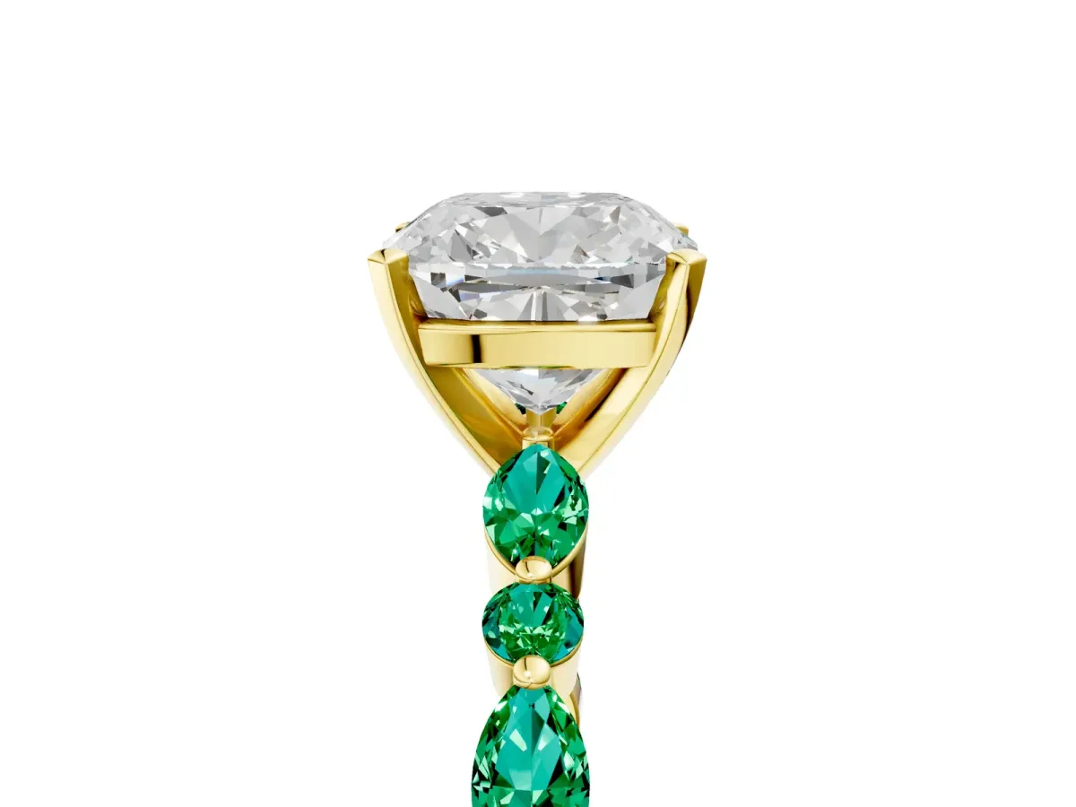 Cushion Cut Diamond Ring with Marquise and Round Emerald Side Stones and Four-Prong Setting Yellow gold