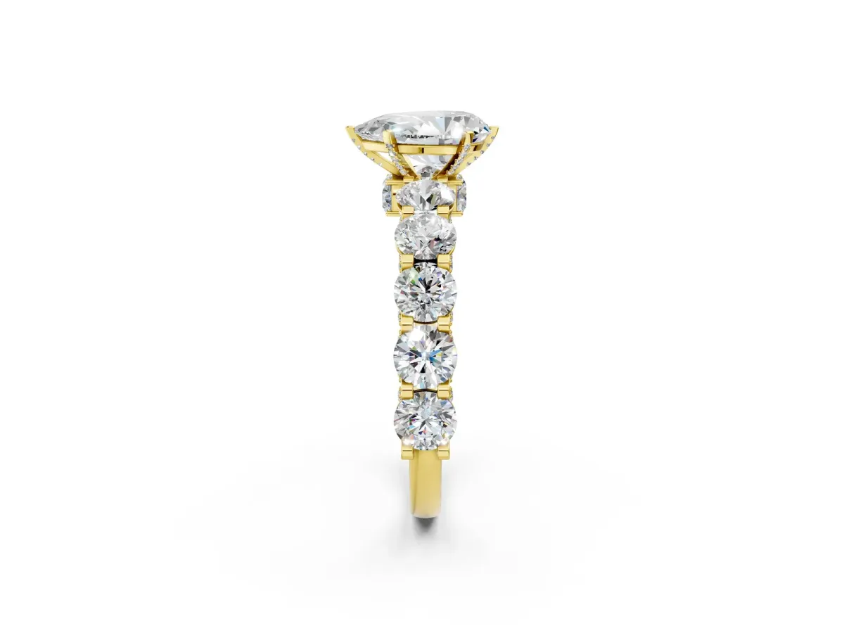 Pear Cut Diamond Side Stone Engagement Ring with Four-Prong Setting Yellow gold