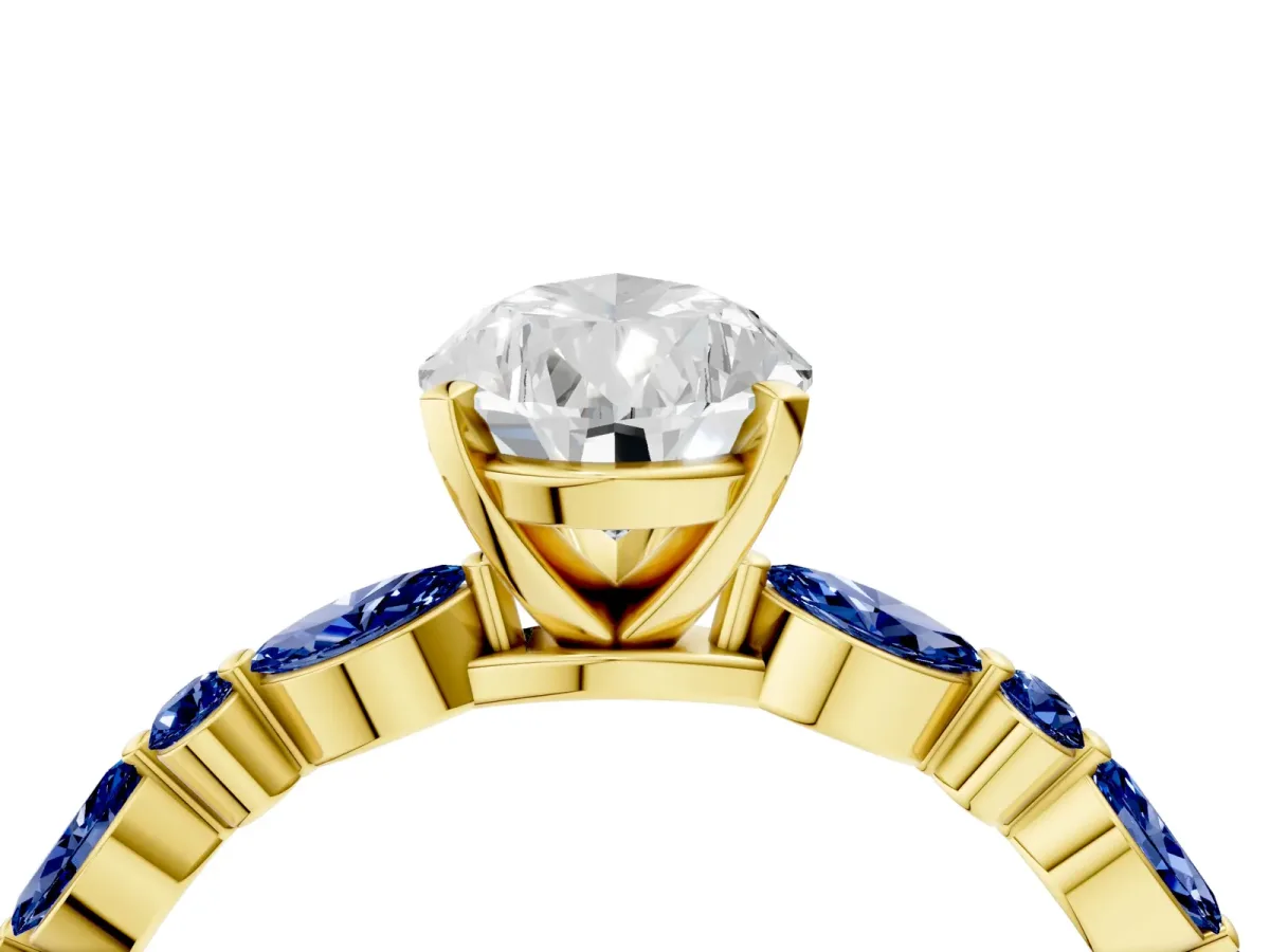 Pear Cut Diamond Ring with Marquise and Round Blue Sapphire Side Stones and Four-Prong Setting Yellow gold