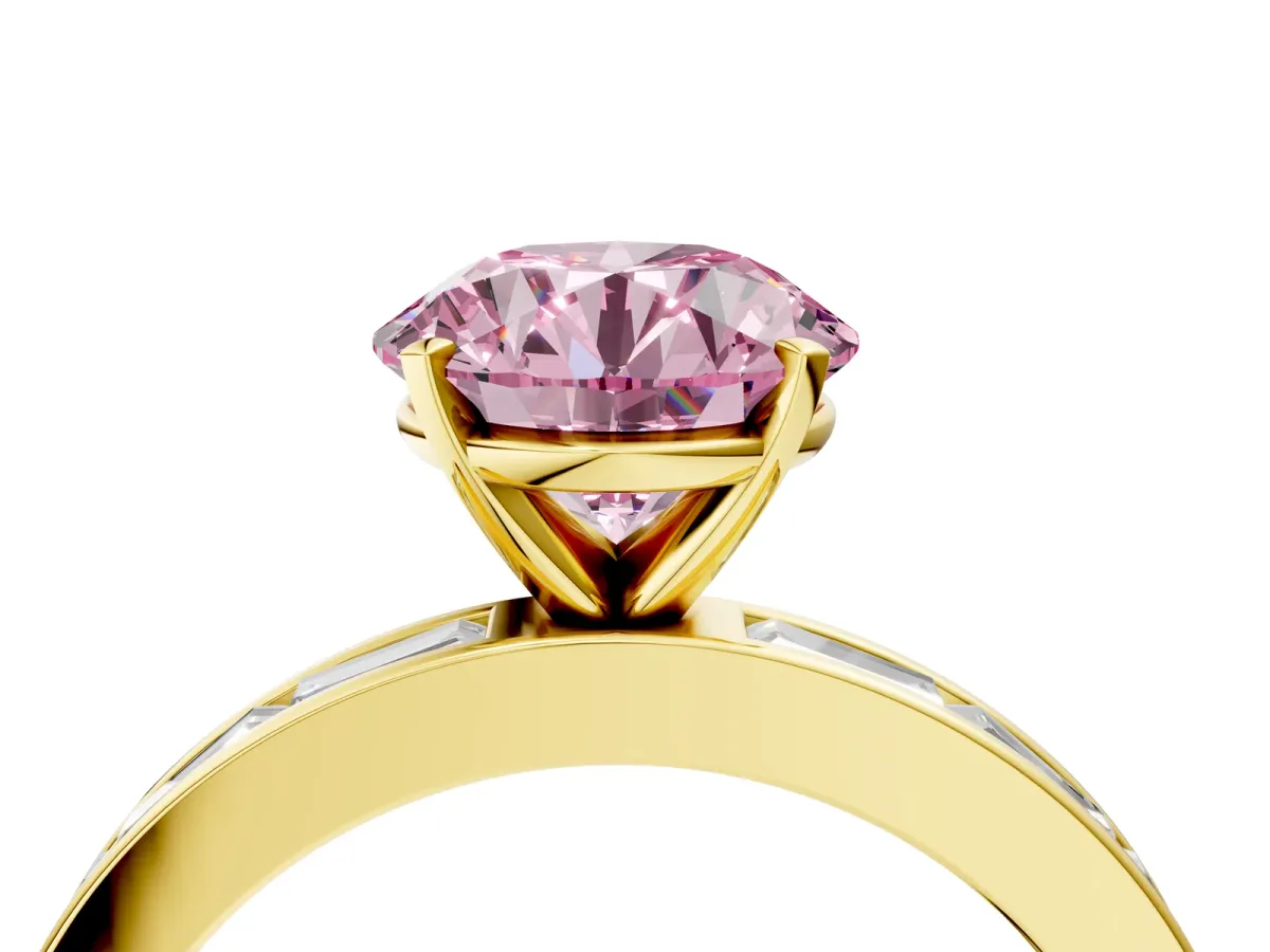 Fancy Pink Round Cut Solitaire Diamond Ring with Channel-Set Baguette Band and Four-Prong Setting Yellow gold