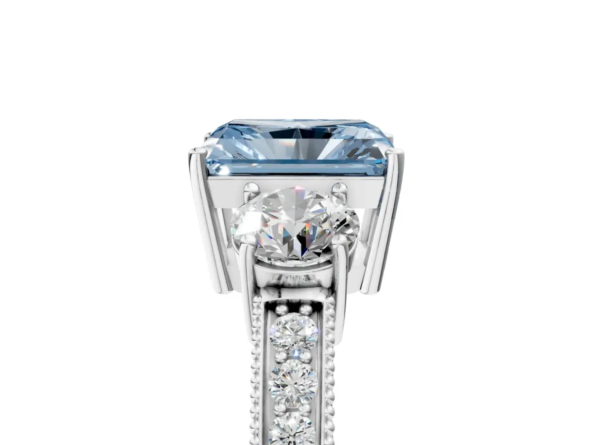 Fancy Blue Radiant Cut Three-Stone Diamond Ring with Pavé Band and Four-Prong Setting Platinum