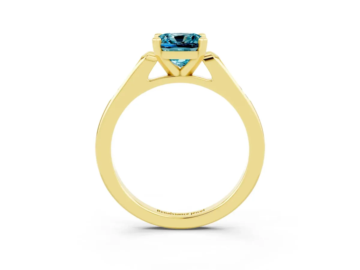 Cushion Cut Blue Topaz Solitaire Ring with Channel Set Round Band and Prong Setting Yellow gold