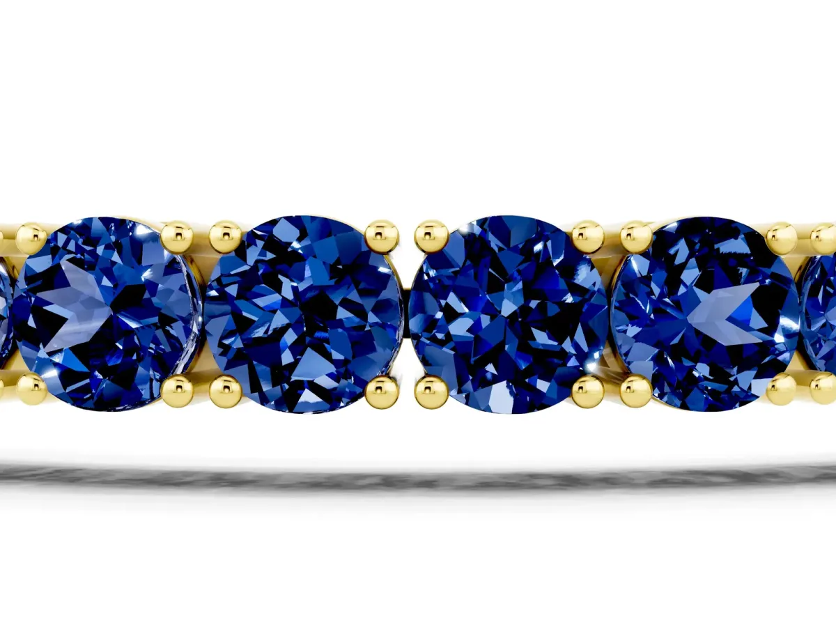 Round Brilliant Blue Sapphire Tennis Bracelet with Prong Setting Yellow gold