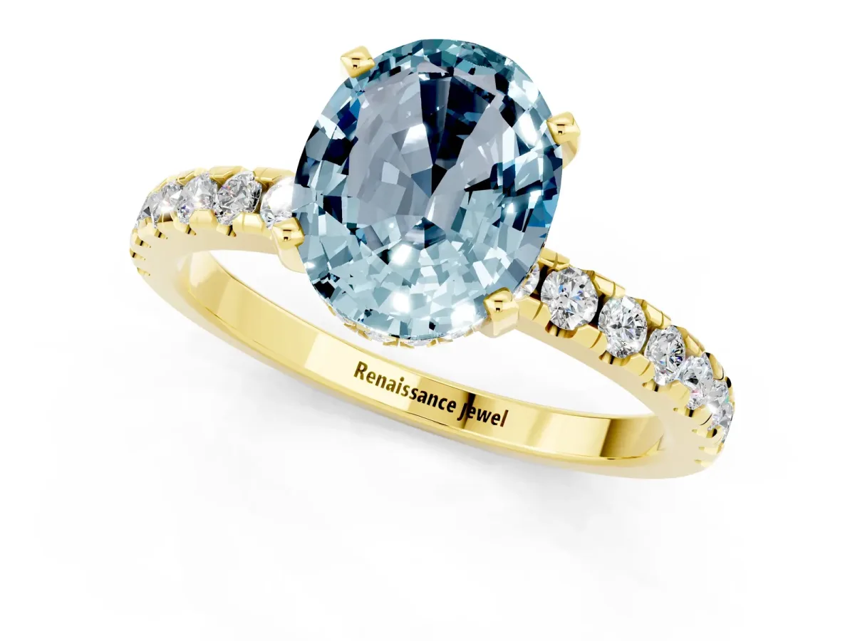Oval Cut Aquamarine Solitaire Ring with Round Pavé Band and Four-Prong Setting Yellow gold