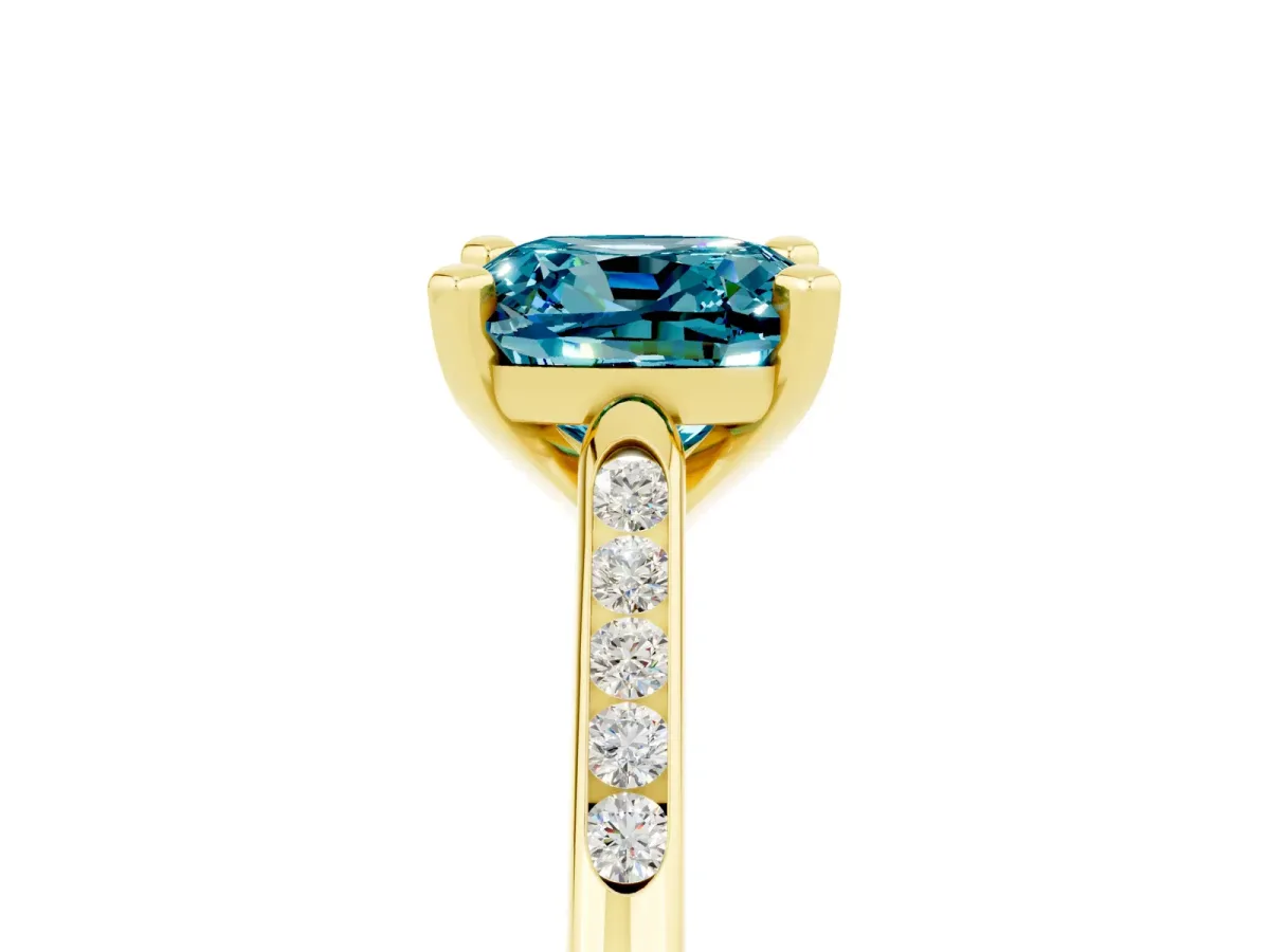 Cushion Cut Blue Topaz Solitaire Ring with Channel Set Round Band and Prong Setting Yellow gold
