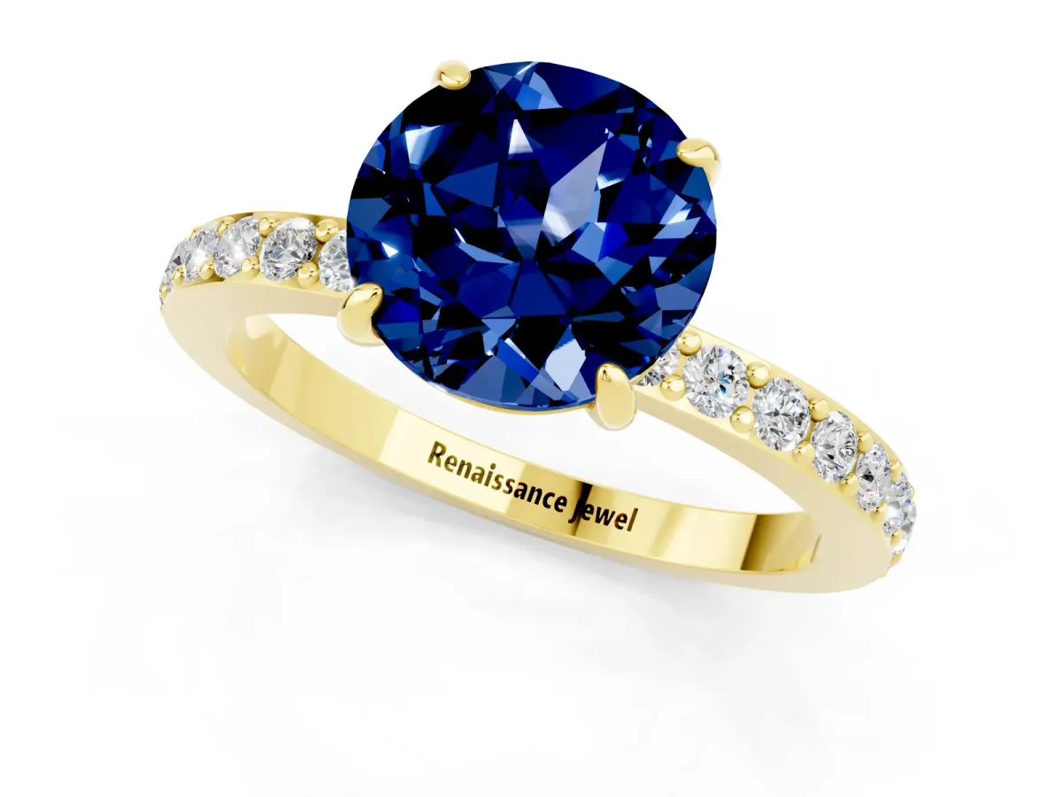 Round Cut Blue Sapphire Solitaire Engagement Ring with Pavé Band and Four-Prong Setting Yellow gold