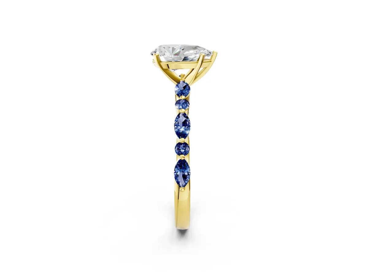 Pear Cut Diamond Ring with Marquise and Round Blue Sapphire Side Stones and Four-Prong Setting Yellow gold
