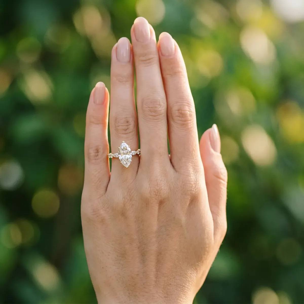 Marquise Cut Diamond Ring with Marquise and Round Side Stones and Four-Prong Setting Yellow gold