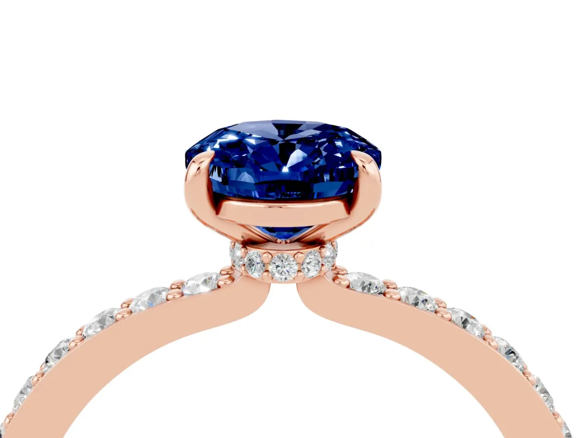 Oval Cut Blue Sapphire Solitaire Engagement Ring with Pavé Band and Four-Prong Setting Rose gold