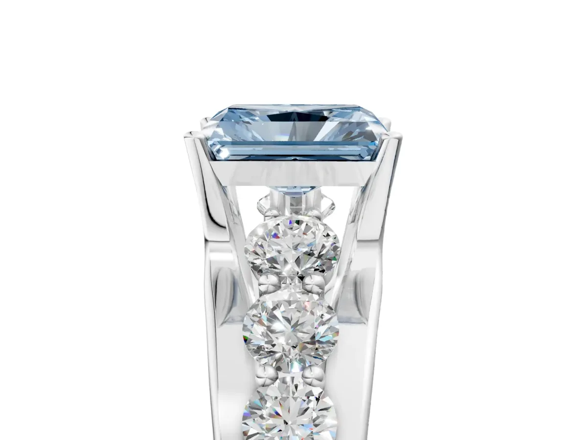 Fancy Blue Radiant Cut Brilliant Solitaire with Side Stones on a Pave Band and Four-Prong Setting Platinum