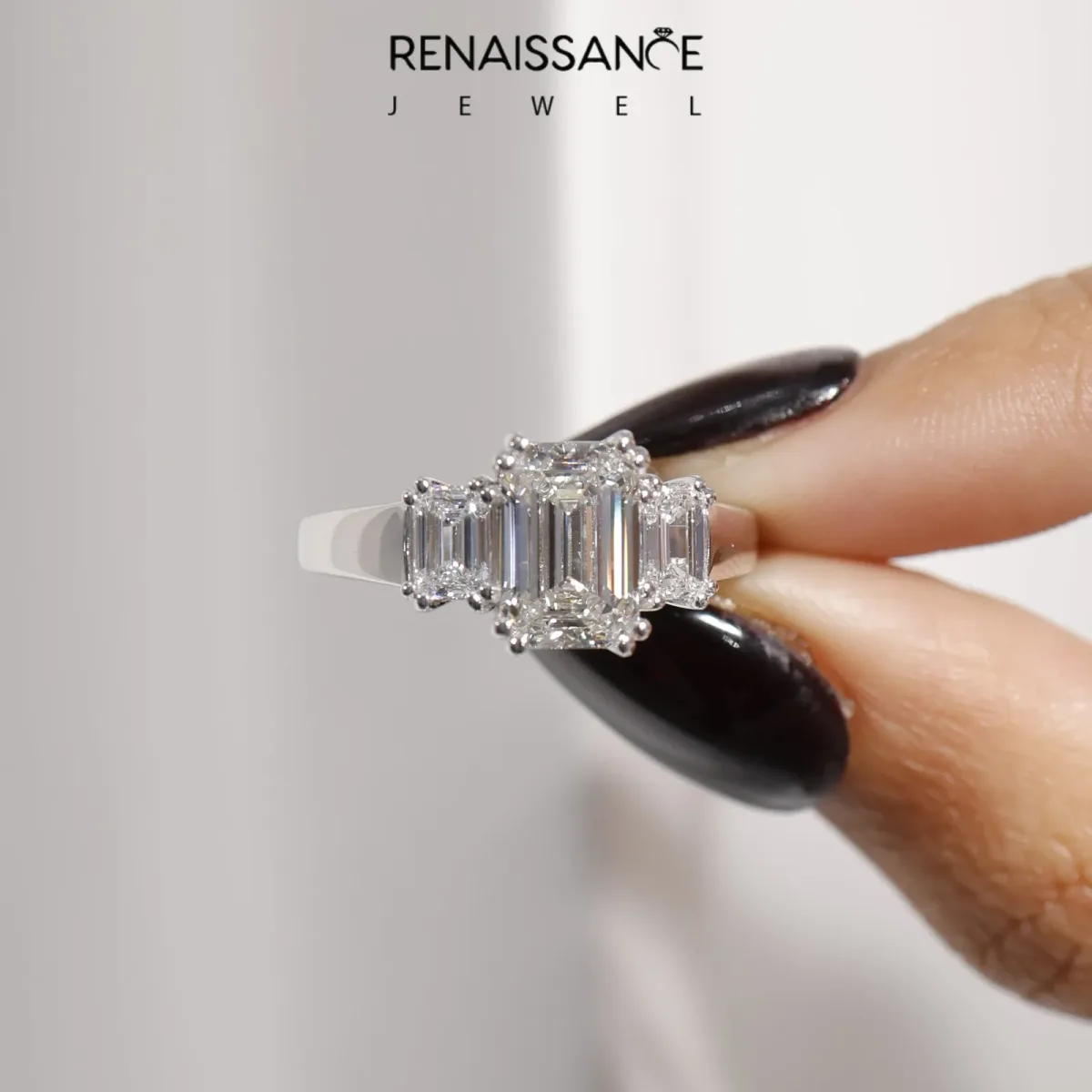 Three-Stone Emerald Cut Cut Diamond Ring with Channel Set Band and Four-Prong Setting Platinum