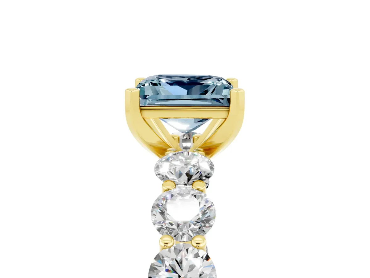 Princess Cut Aquamarine Prong Setting with Side Stones on a Pave Band Yellow gold