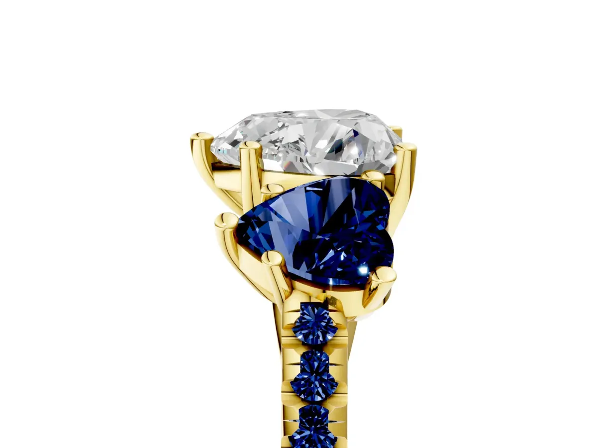 Three-Stone Heart Cut Diamond Ring with Round Blue Sapphire Pavé Band and Prong Setting Yellow gold