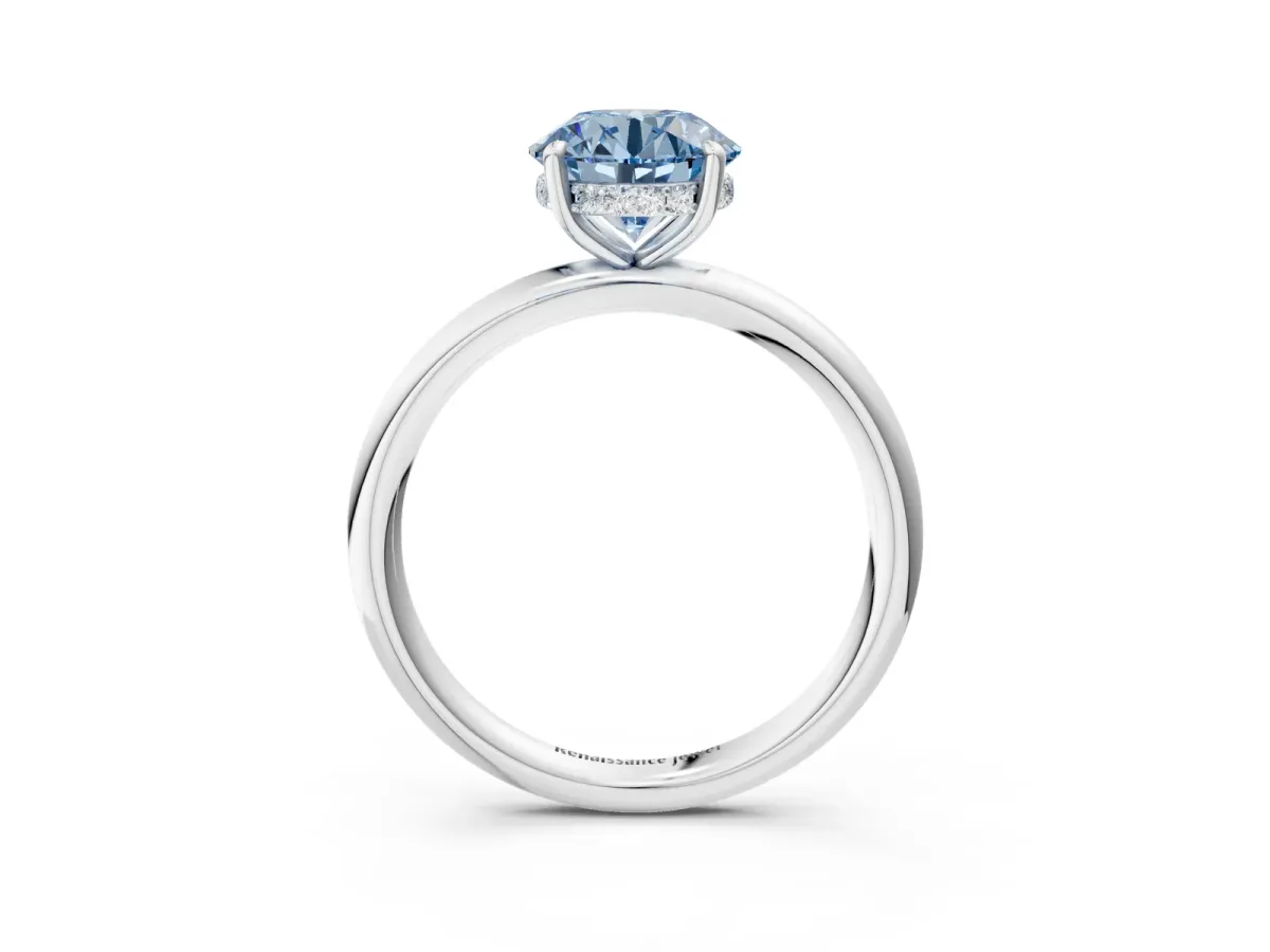 Fancy Blue Round Cut Diamond Solitaire Ring with Thin Band and Four-Prong Setting Silver