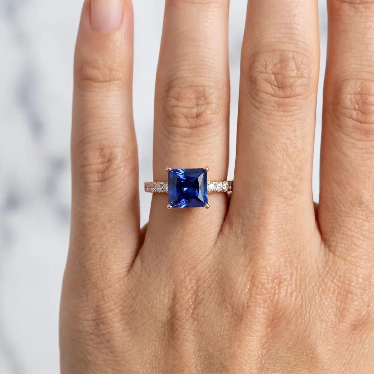 Princess Cut Blue Sapphire Solitaire Ring with Round Pavé Band and Four-Prong Setting Rose gold