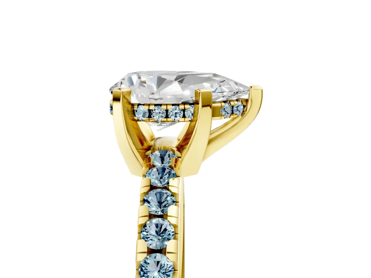 Pear Cut Diamond Solitaire Ring with Round Aquamarine Pavé Band and Four-Prong Setting Yellow gold