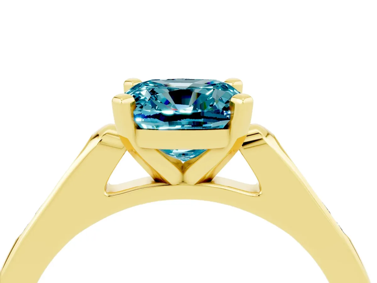 Cushion Cut Blue Topaz Solitaire Ring with Channel Set Round Band and Prong Setting Yellow gold