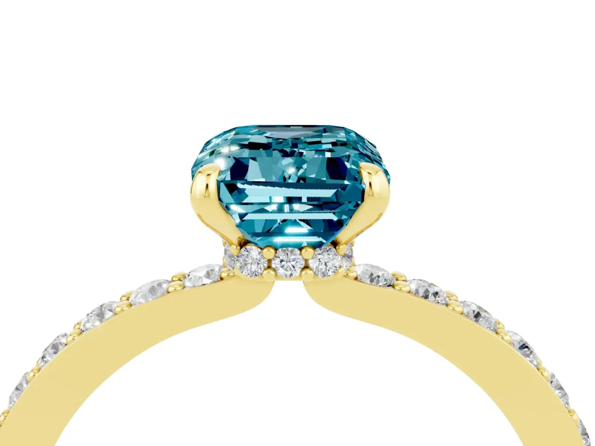 Emerald Cut Blue Topaz Solitaire Engagement Ring with Pavé Band and Four-Prong Setting Yellow gold