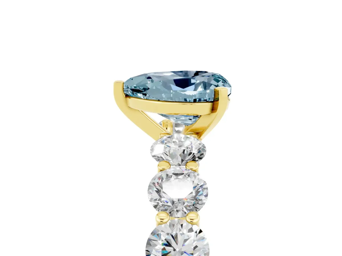 Heart Cut Aquamarine Prong Setting with Side Stones on a Pave Band Yellow gold