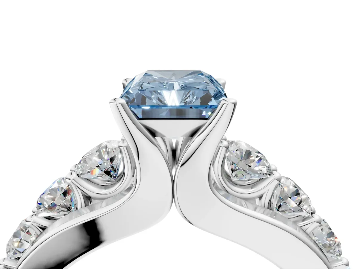 Fancy Blue Radiant Cut Brilliant Solitaire with Side Stones on a Pave Band and Four-Prong Setting Platinum