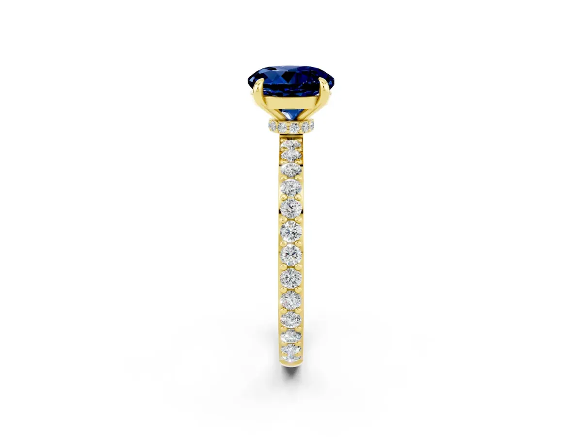 Round Cut Blue Sapphire Solitaire Engagement Ring with Pavé Band and Four-Prong Setting Yellow gold