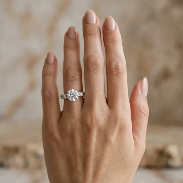 Round Cut Diamond Side Stone Engagement Ring with Four-Prong Setting Platinum